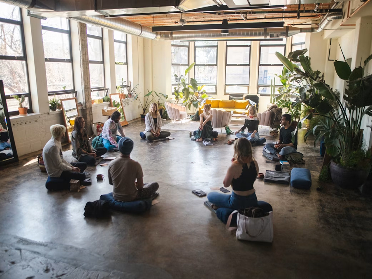 A group of people sitting in a circle in a room